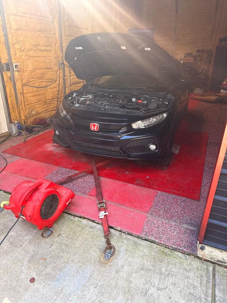 Car strapped to the chassis dyno at NC Diesel and Dyno